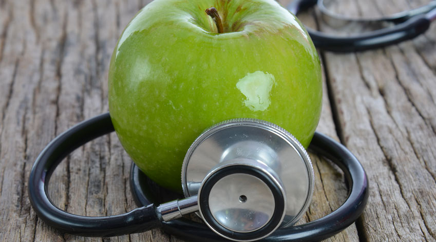 Apple and stethoscope. 