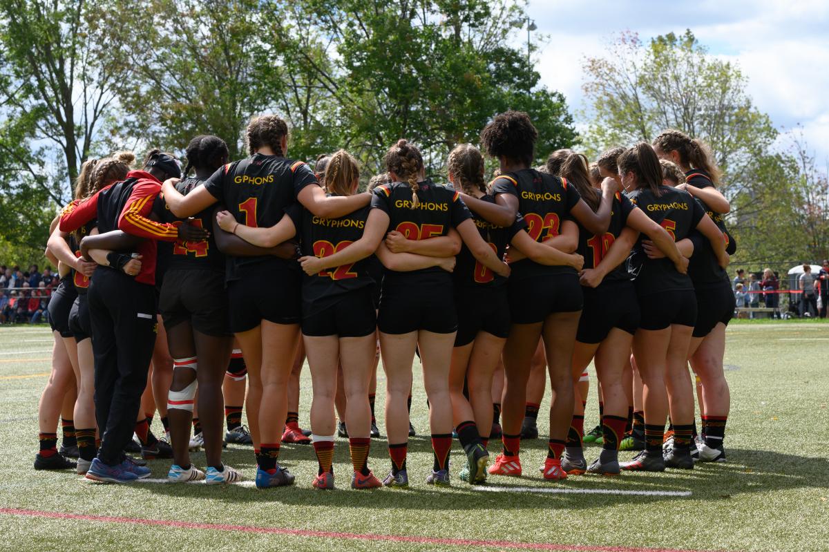 women's rugby team huddle
