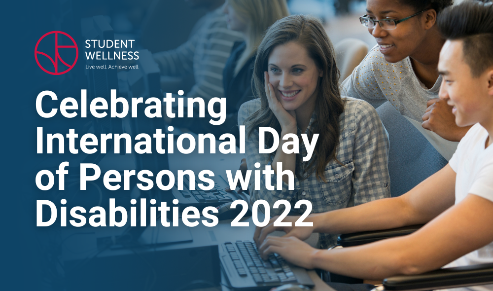 Two women and one man smiling while looking at a computer. The main is in a wheelchair. Text reads Celebrating International Day of Persons with Disabilities 2022