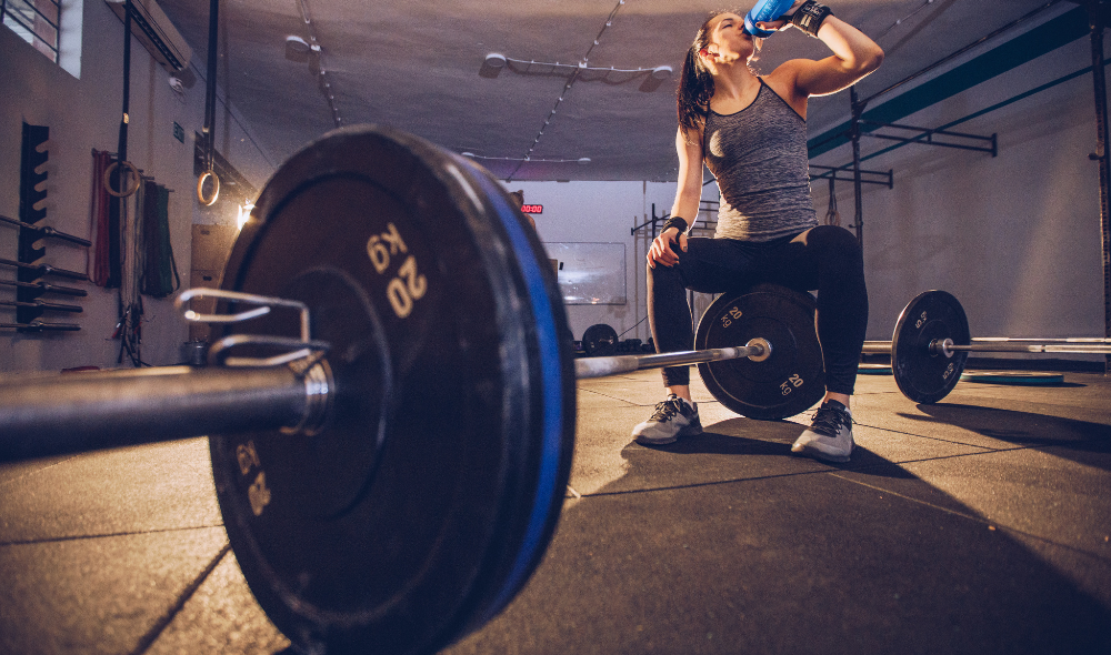 HPC Guelph Fuelling Your Body for Fitness For Woman. Woman drinking water after weight lifting