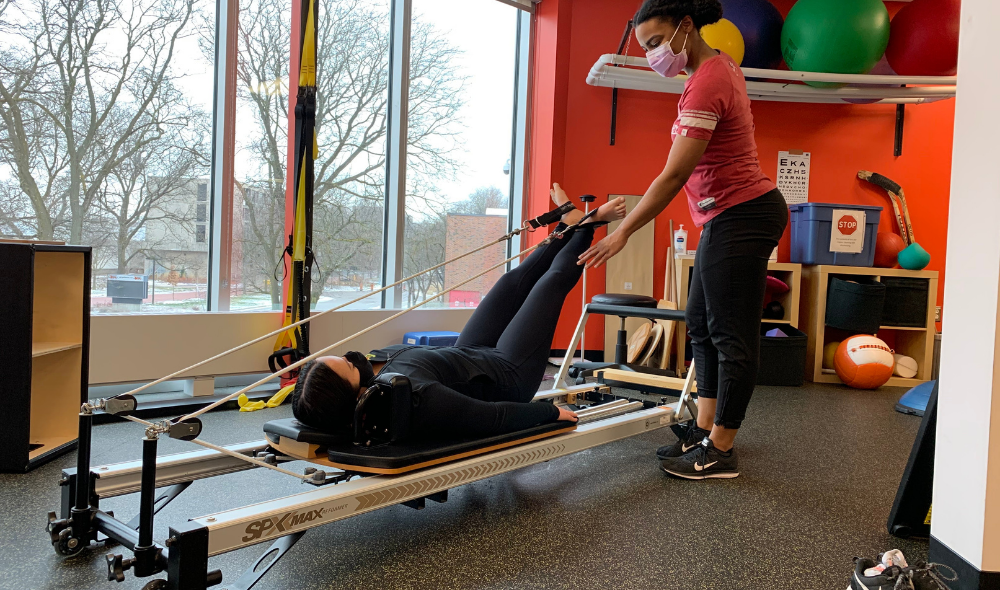 Physio Pilates Physiotherapist Jeannette Johnson supporting a physio pilates reformer client at the HPC Guelph